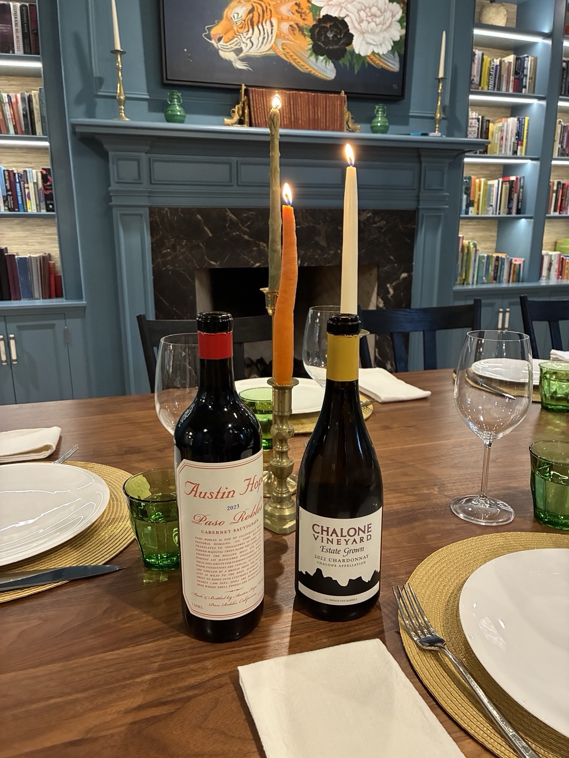 Two selected wine bottles on a fully set dining table